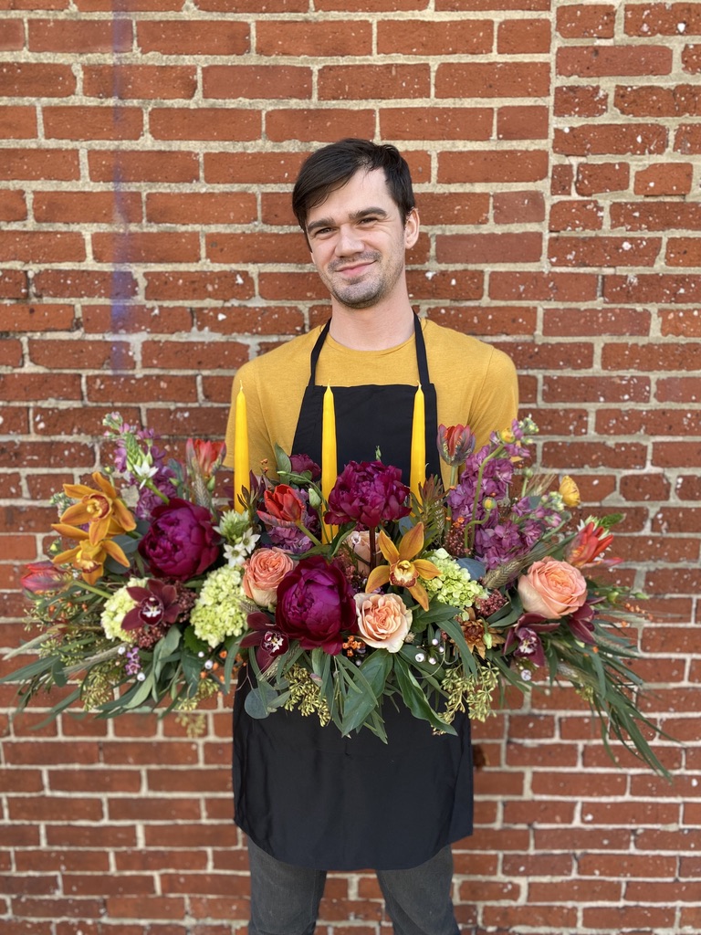 Edward Berkoski holding a floral arrangement